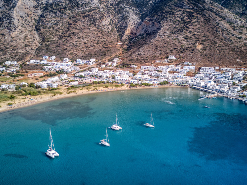 Aerial,View,Of,Sailboats,Anchored,In,The,Turquoise,Kamares,Bay